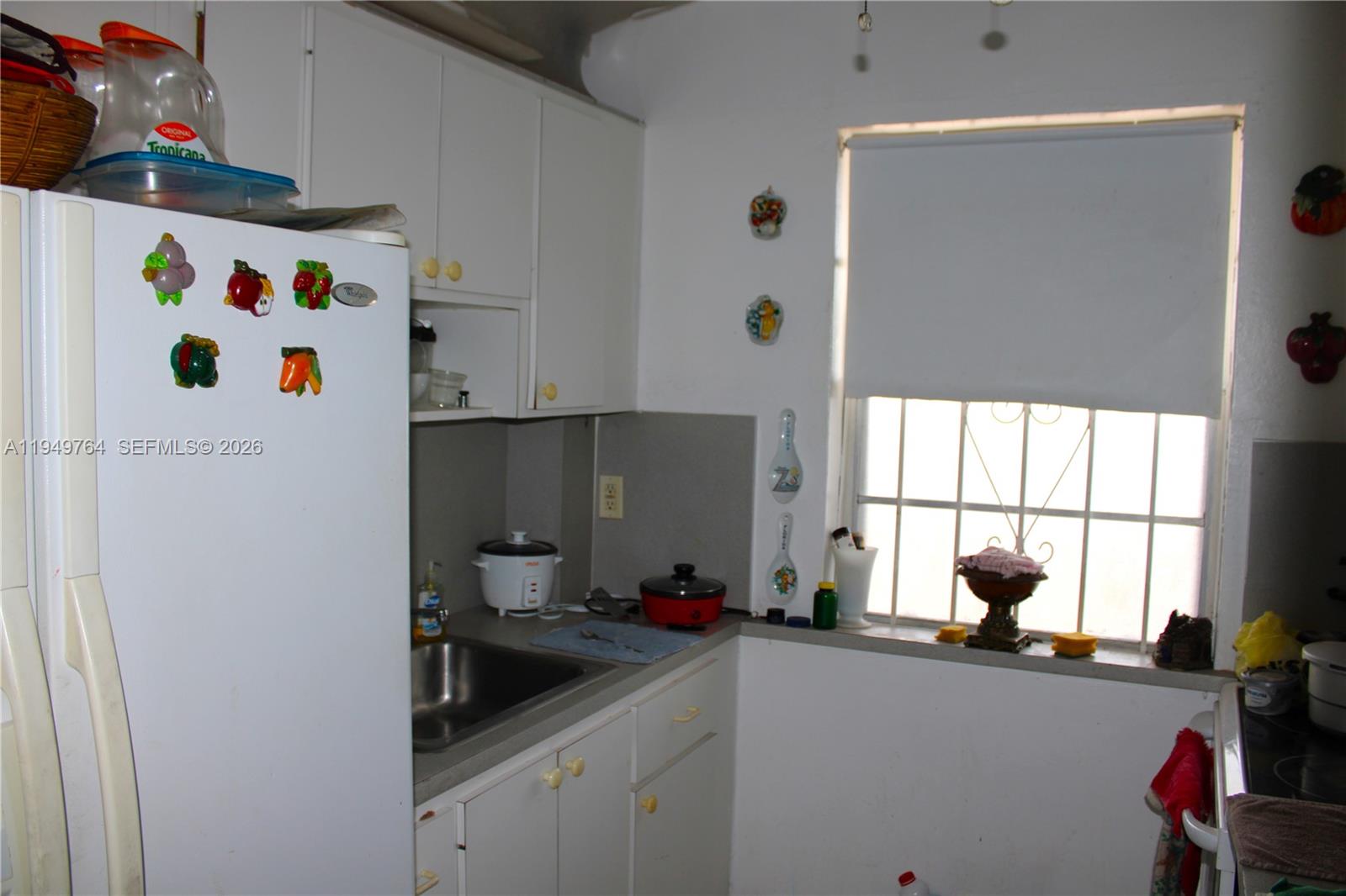 1154 West 35th Street, Unit 221 Hialeah, FL 33012 - Photo 21 of 39 a kitchen with a refrigerator and window