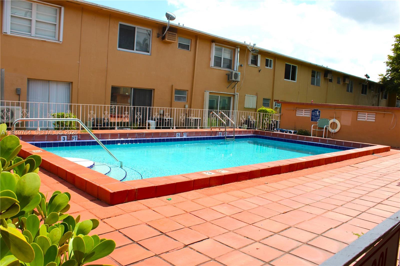 1154 West 35th Street, Unit 221 Hialeah, FL 33012 - Photo 30 of 39 a backyard with table and chairs