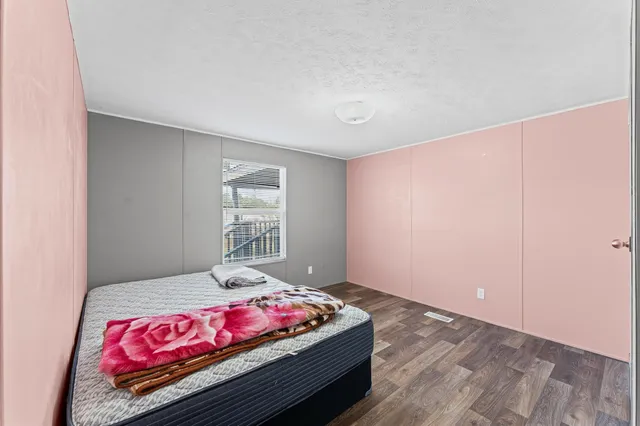 a bedroom with a bed and a dresser