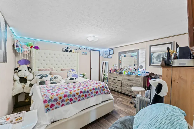 a bathroom with a granite countertop sink vanity mirror and toilet