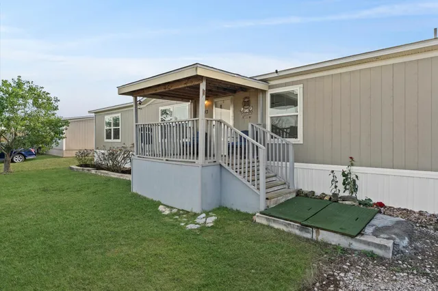 a balcony with chairs and wooden floor