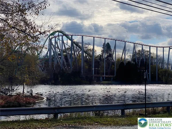 a kitchen that has a lot of white cabinets and stainless steel appliances