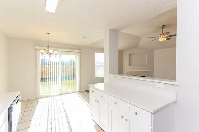 a spacious bathroom with a shower a sink and a mirror