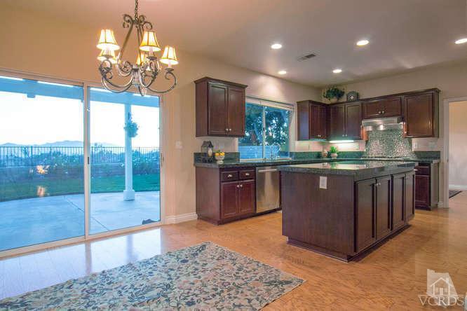 2480 Rutland Place Thousand Oaks, CA 91362 - Photo 5 of 23 a kitchen with kitchen island granite countertop a stove and a view of living room
