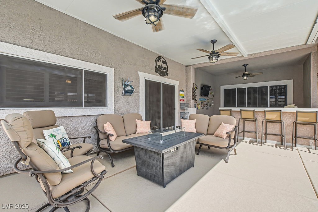 647 Foxhall Road Henderson, NV 89002 - Photo 42 of 82 View of patio with an outdoor living space, a ceiling fan, and outdoor dry bar