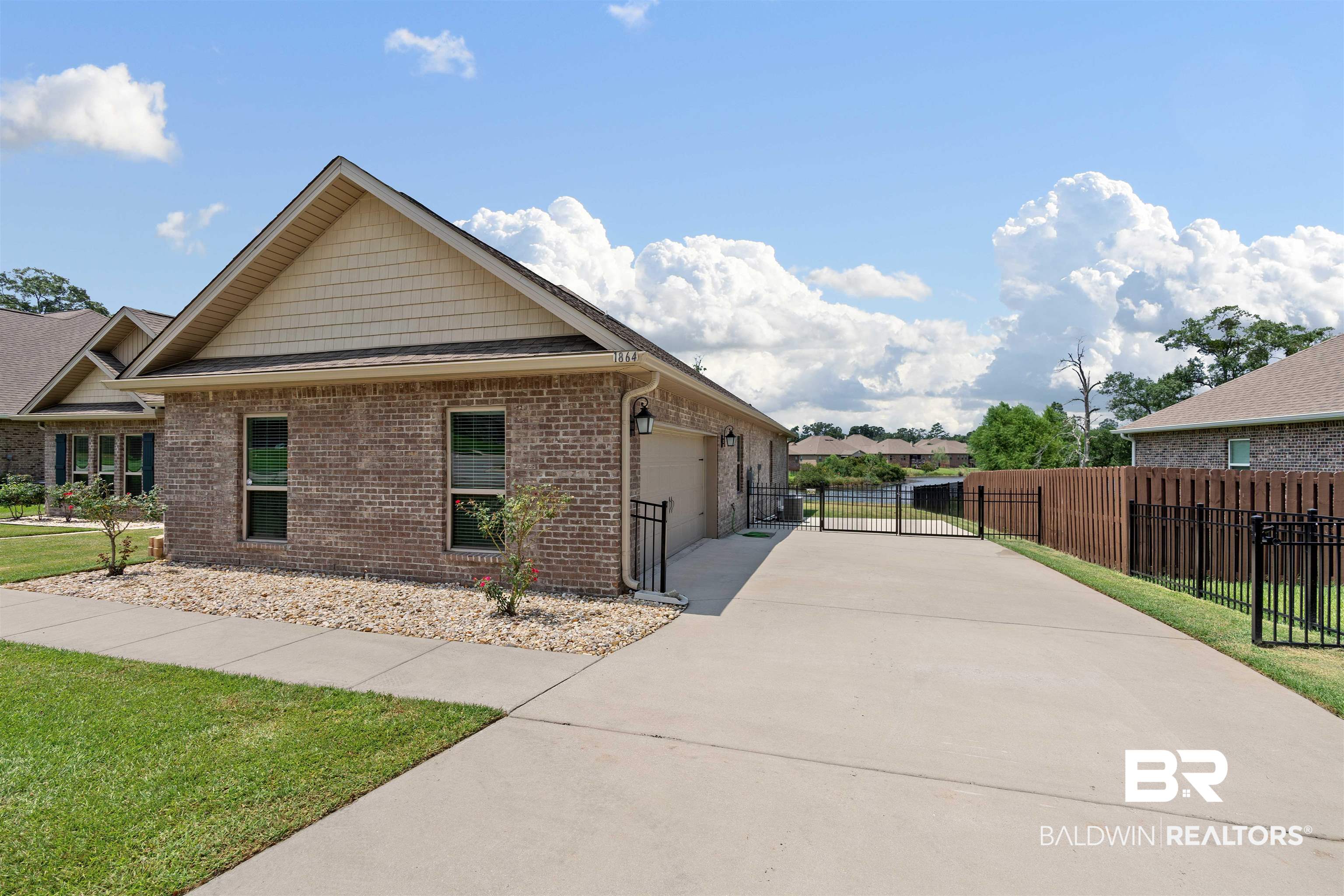 1864 Gwin Court Mobile, AL 36695 - Photo 5 of 37 View of property exterior with a lawn and a garage