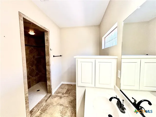 a bathroom with a bathtub and a shower