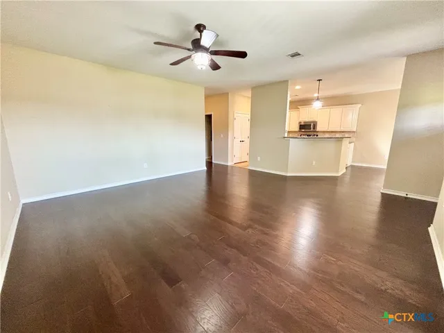 a view of a kitchen with a sink and a refrigerator