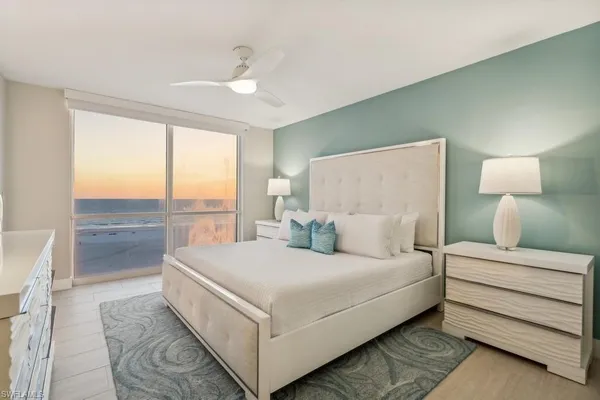 a large white bed in a white room