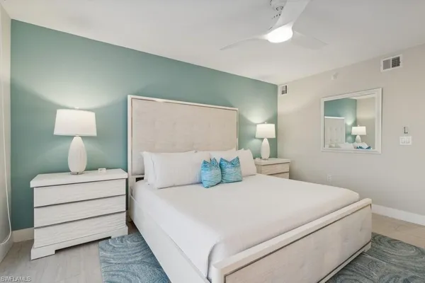 a bedroom with a bed and a lamp