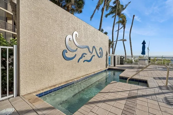 a view of a lake with boats and palm trees