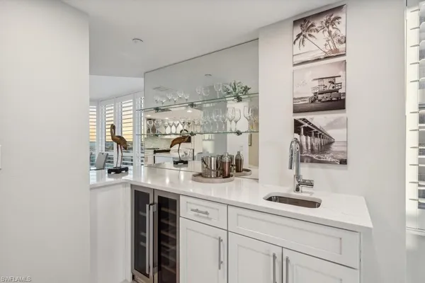 a kitchen with kitchen island a sink appliances and cabinets