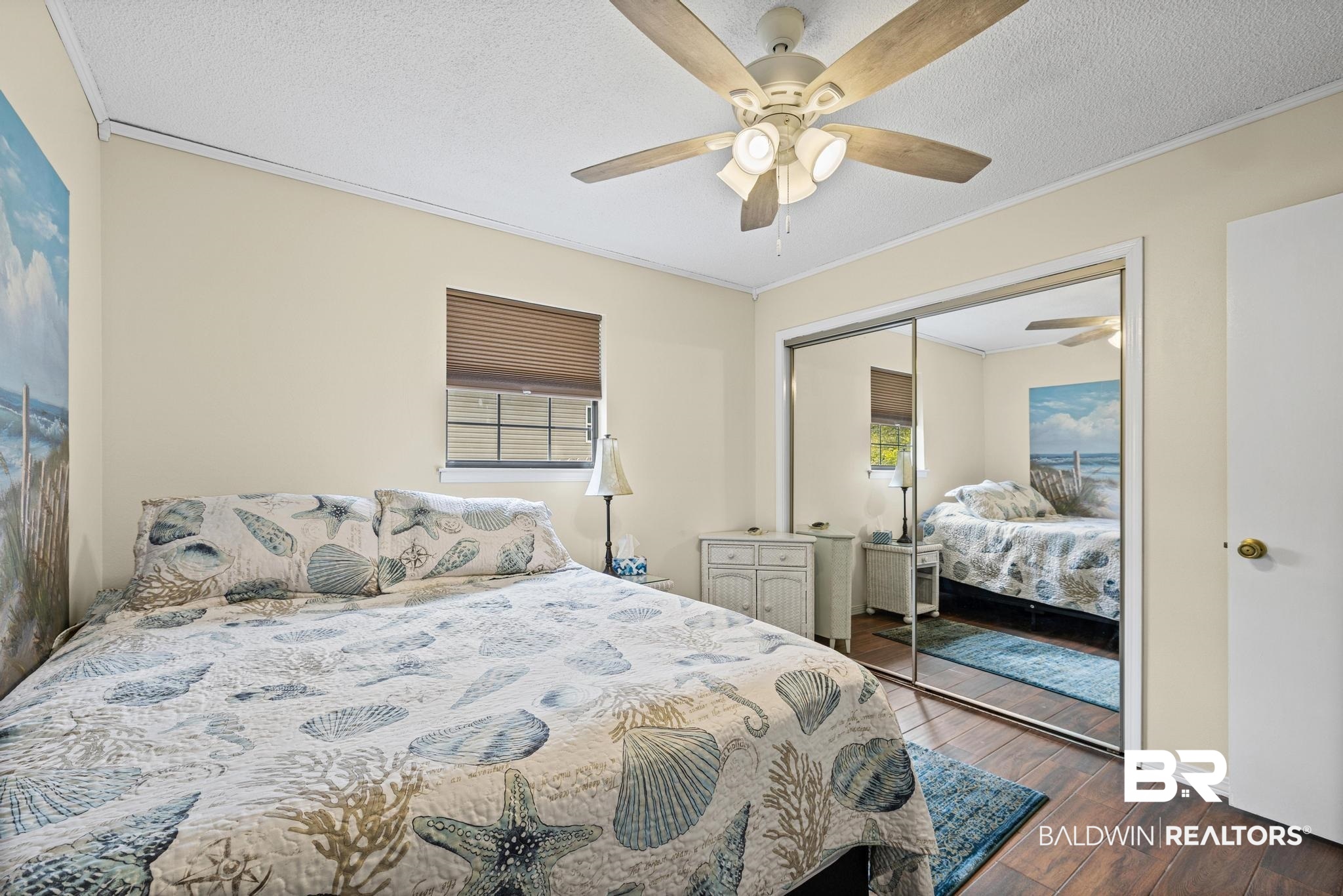 1437 Rio Circle Lillian, AL 36549 - Photo 19 of 46 Bedroom with crown molding, dark wood-style floors, a ceiling fan, a textured ceiling, and a closet