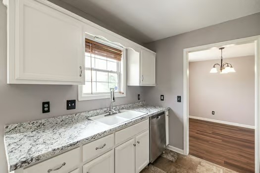 2029 Copper Kettle Circle Pleasant View, TN 37146 - Photo 22 of 58 a kitchen with granite countertop cabinets sink and window