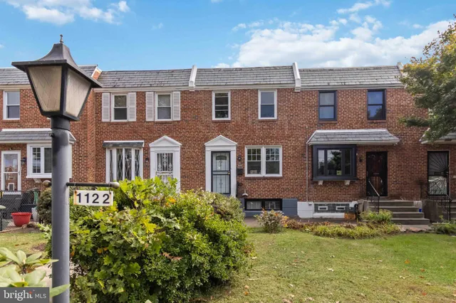a front view of a house with a yard table and chairs