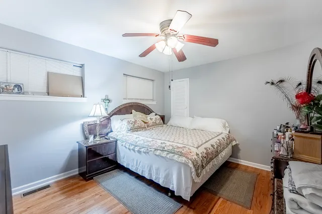 a bedroom with bed and a chandelier