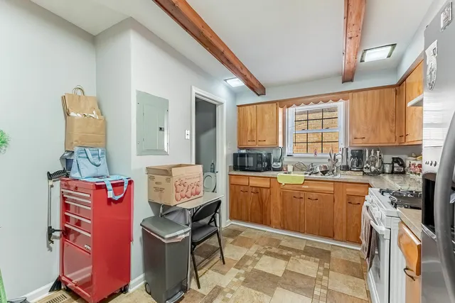 a kitchen with stainless steel appliances granite countertop a stove top oven a sink dishwasher and cabinets with wooden floor