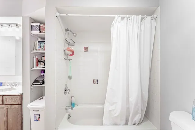 a bathroom with a shower curtain and a curtain