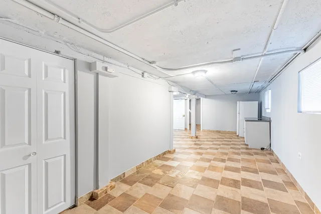 a view of a hallway with closet and wooden floor