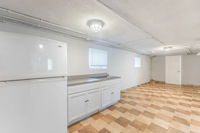 a kitchen with a stove a sink and a refrigerator