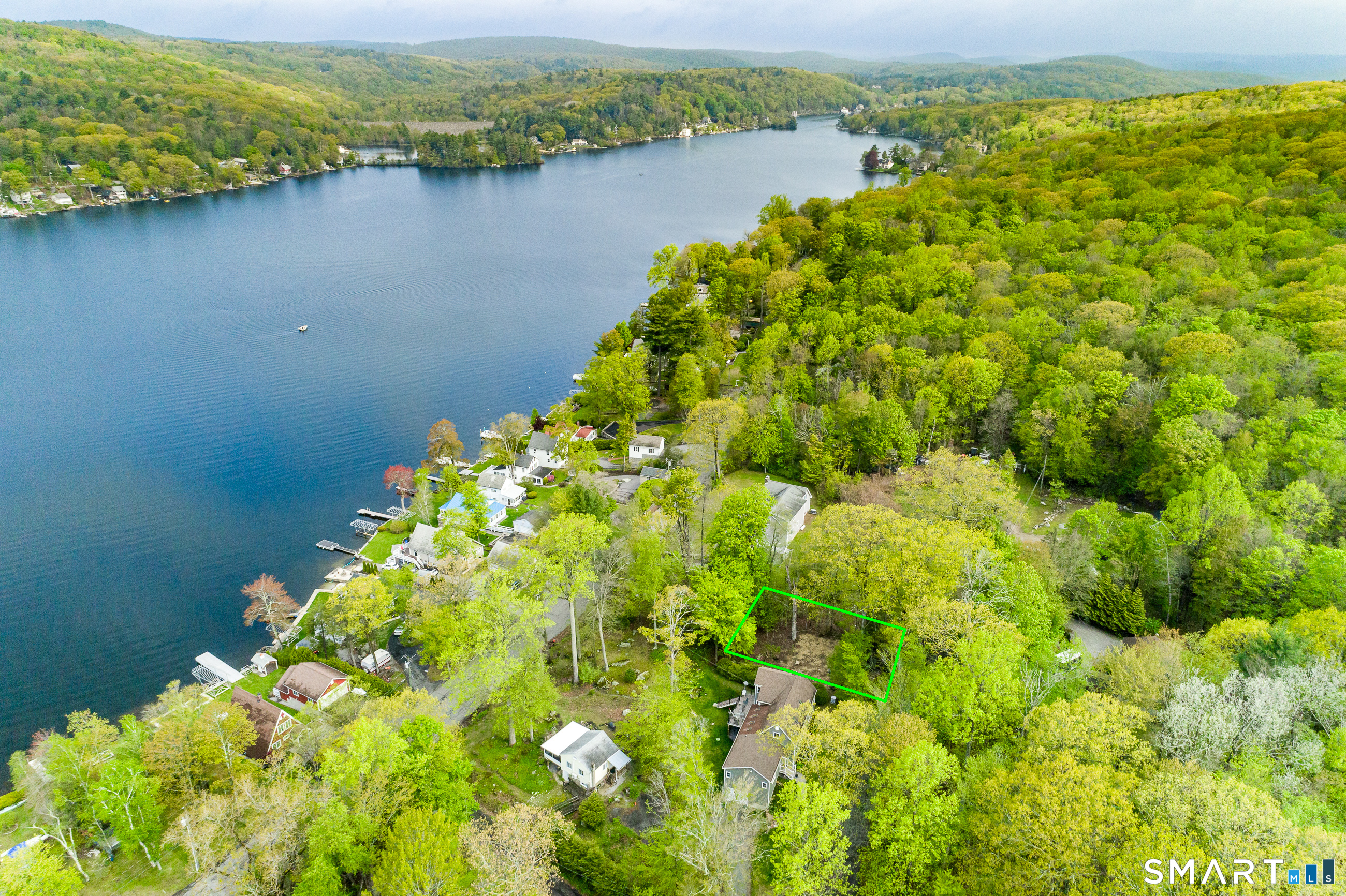 624 Wynne Road Winchester, CT 06098 - Photo 7 of 22 a view of a lake with a mountain in the background