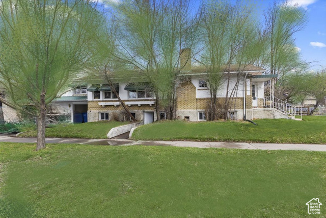 207 East 300 North Logan, UT 84321 - Photo 1 of 1 View of community with a garage and a lawn