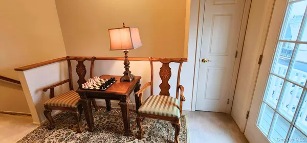 a balcony with a table and chairs