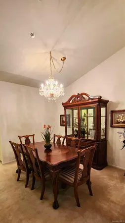a view of a dining room with furniture and chandelier