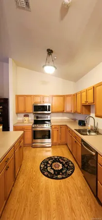 a kitchen with a stove a sink and a refrigerator