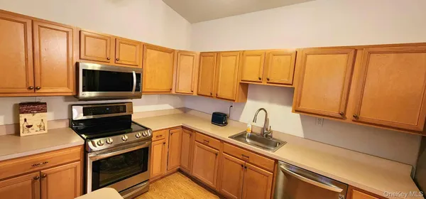 a kitchen with a sink a stove and cabinets