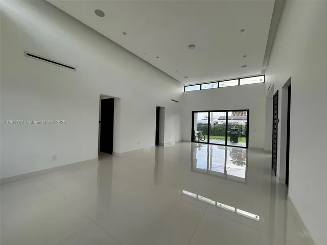 an empty room with windows and entrance