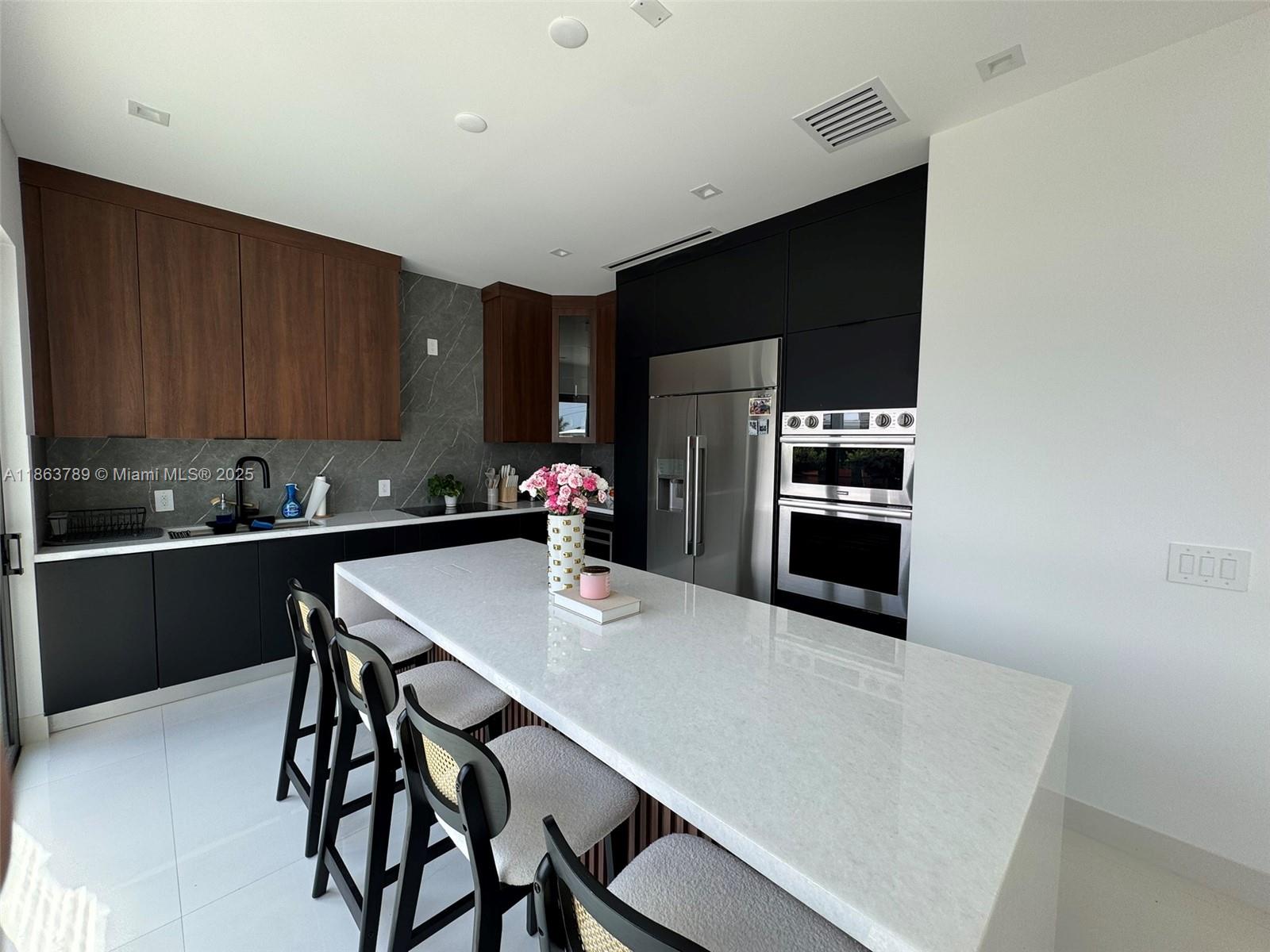 10960 Southwest 42nd Terrace Miami, FL 33165 - Photo 18 of 38 a kitchen with stainless steel appliances a sink a stove a refrigerator and cabinets