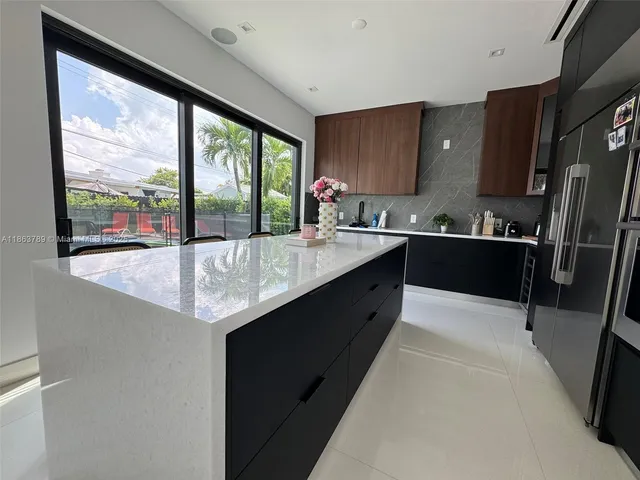 a kitchen with a sink a counter top space and stainless steel appliances