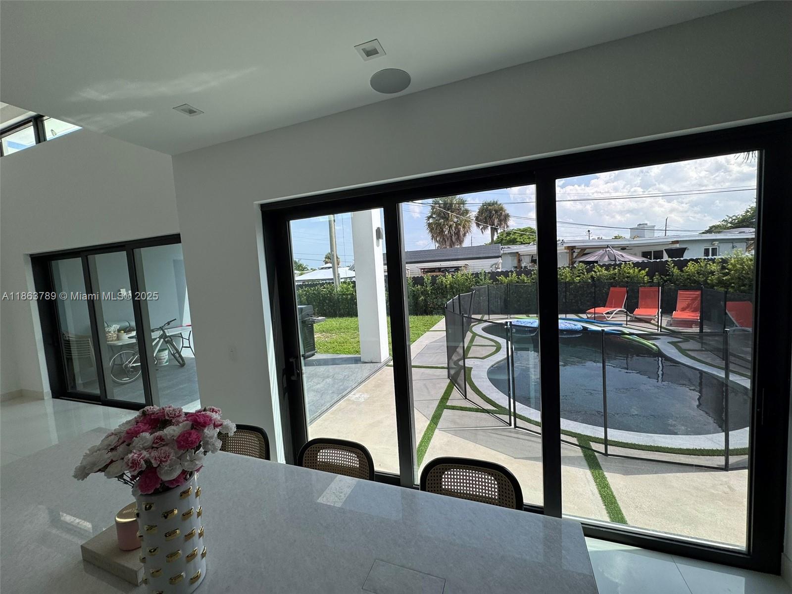 10960 Southwest 42nd Terrace Miami, FL 33165 - Photo 22 of 38 a view of a living room and floor to ceiling window or kitchen