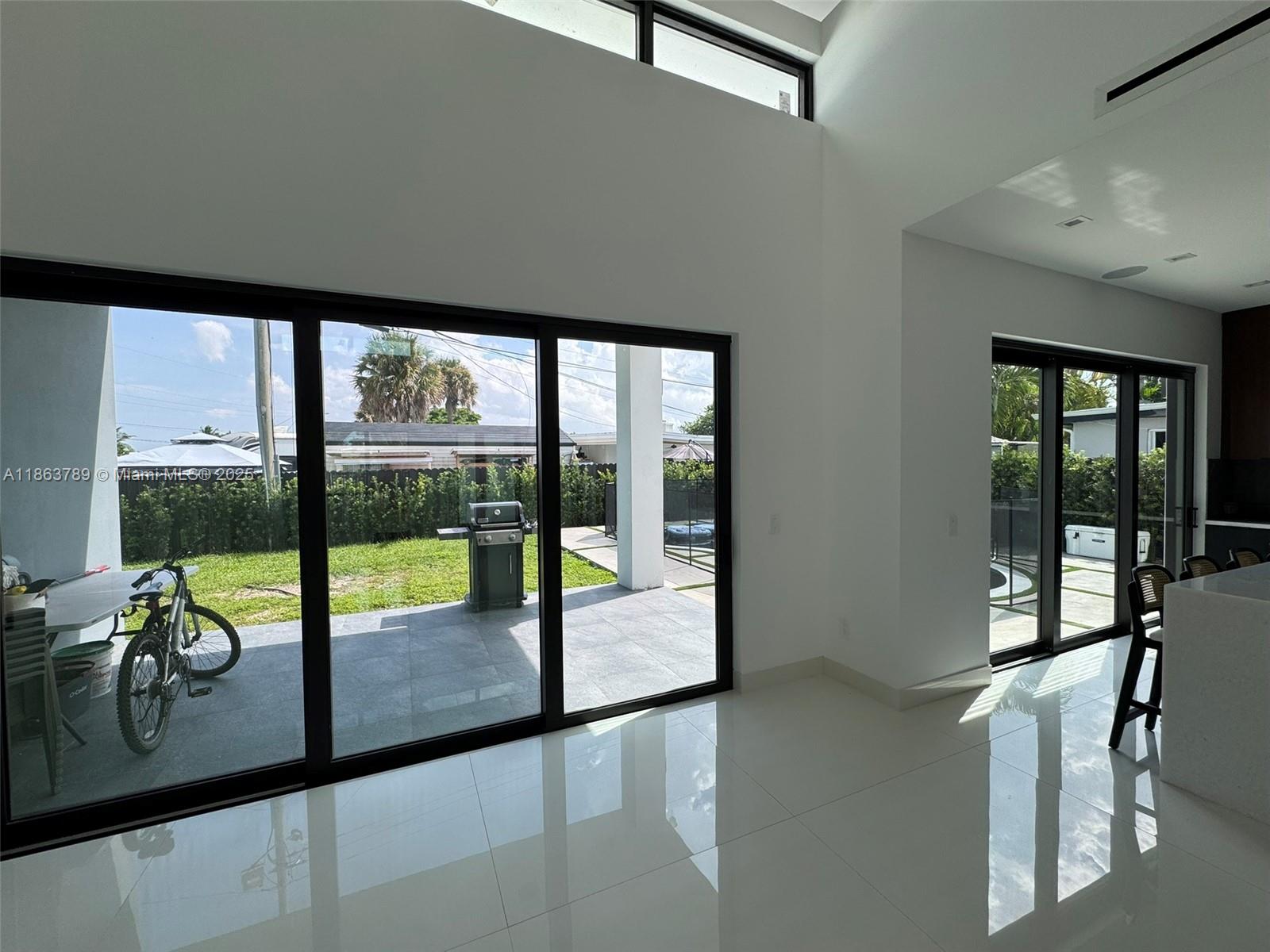 10960 Southwest 42nd Terrace Miami, FL 33165 - Photo 23 of 38 a view of a living room and floor to ceiling window