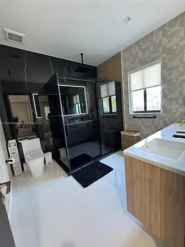 a living room with hard wood floors and furniture