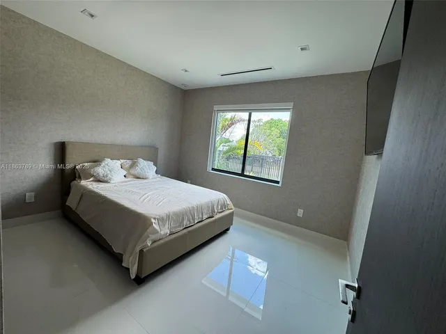 a bedroom with a bed and window