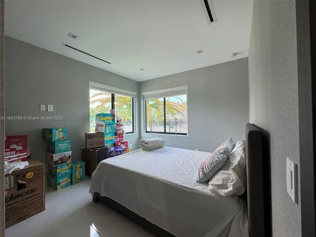 a bedroom with a bed closet and a window