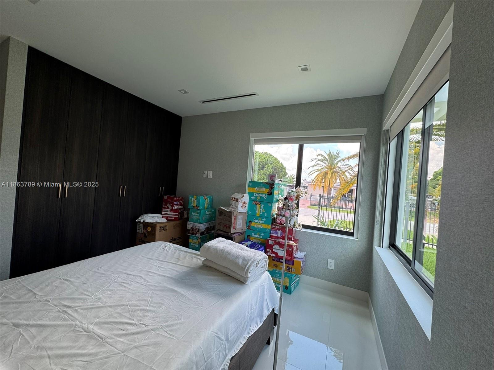 10960 Southwest 42nd Terrace Miami, FL 33165 - Photo 34 of 38 a bedroom with a bed and a large window