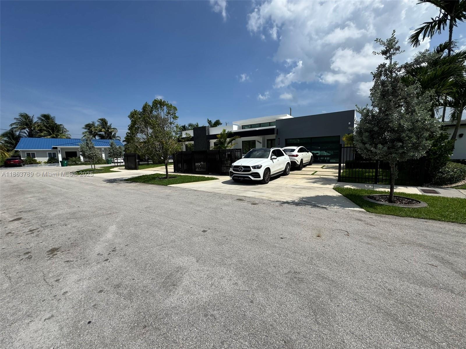 10960 Southwest 42nd Terrace Miami, FL 33165 - Photo 7 of 38 a view of a yard with table and chairs under an umbrella