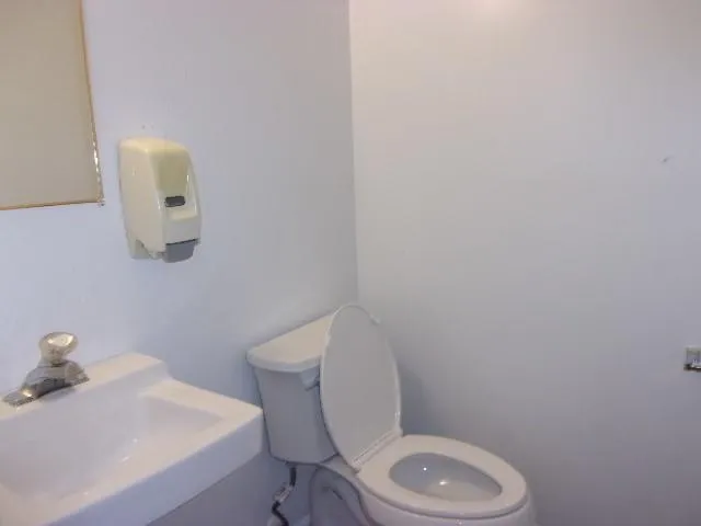 a white toilet sitting next to a bathroom sink