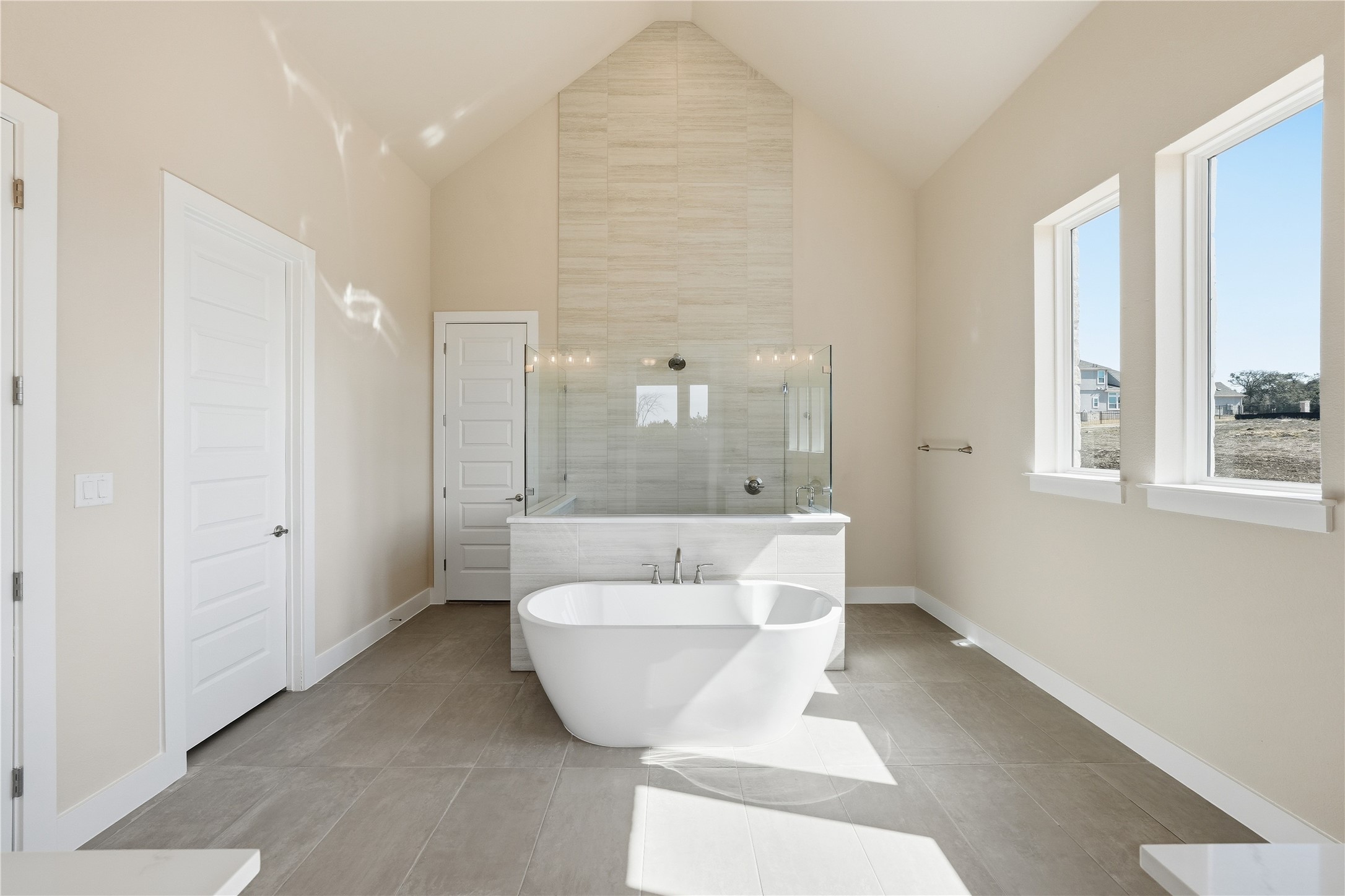 1209 Doelling Drive Georgetown, TX 78633 - Photo 13 of 31 Full bath featuring walk in shower, a freestanding tub, a high ceiling, and light tile patterned floors