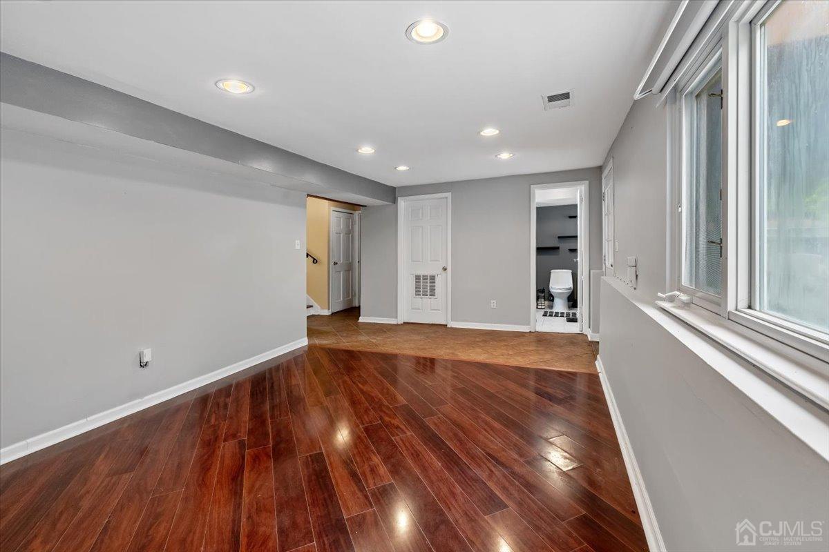 15 Drake Road Somerset, NJ 08873 - Photo 11 of 27 an empty room with wooden floor and windows
