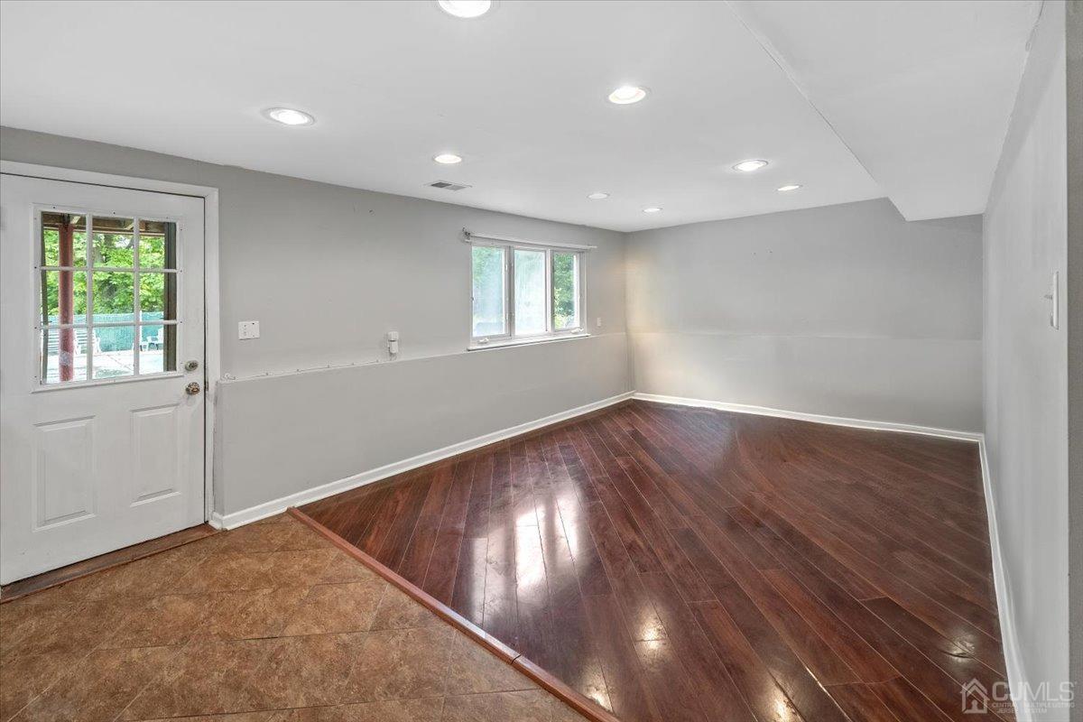 15 Drake Road Somerset, NJ 08873 - Photo 12 of 27 an empty room with wooden floor and windows