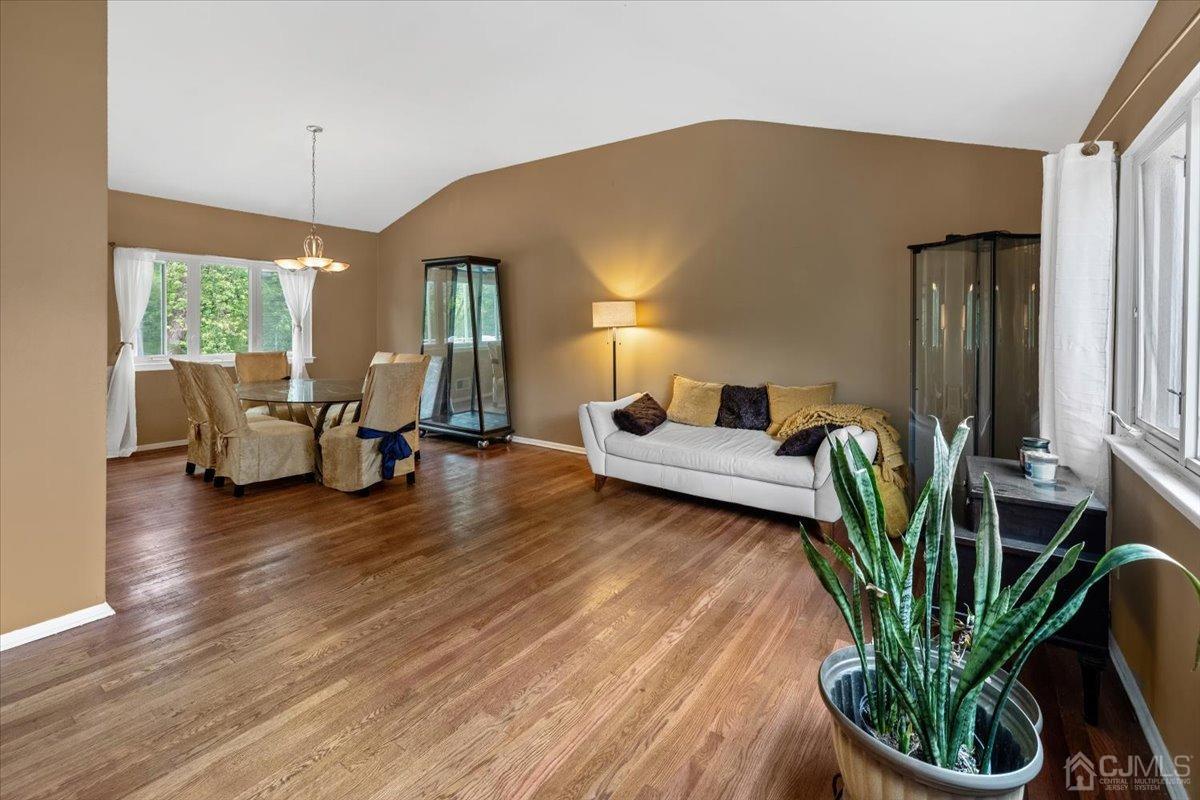 15 Drake Road Somerset, NJ 08873 - Photo 5 of 27 a living room with furniture floor to ceiling window and potted plants