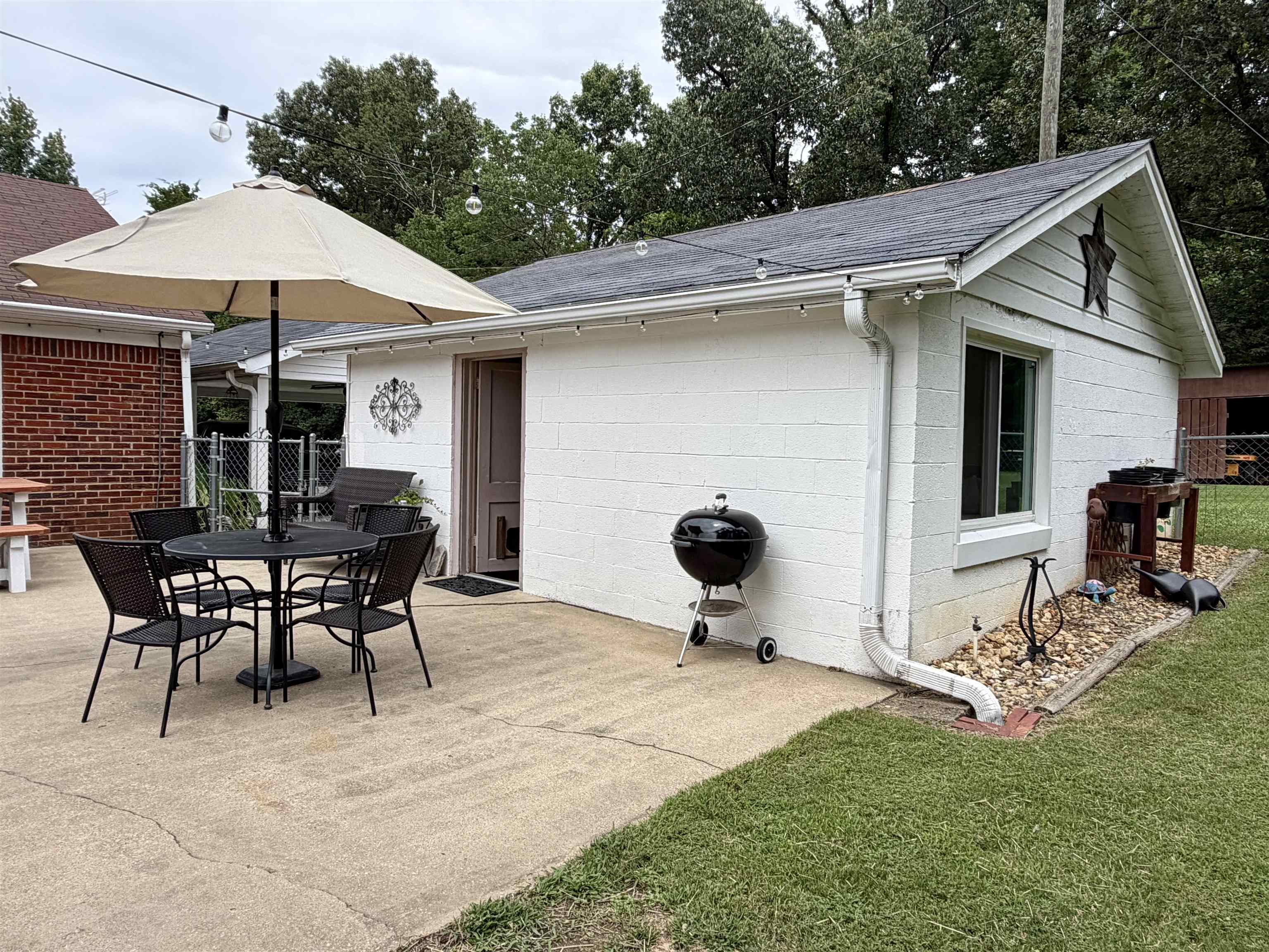 206 Burns Road Ramer, TN 38367 - Photo 26 of 37 Concrete patio area bordered by a manicured lawn