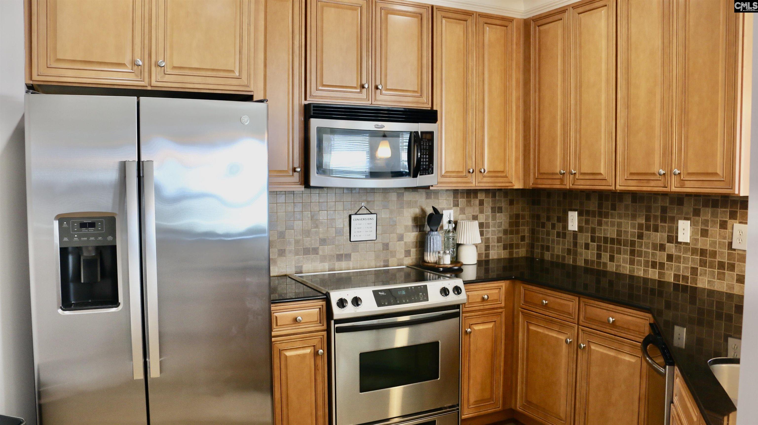 601 Main Street, Unit 323 Columbia, SC 29201 - Photo 10 of 68 a kitchen with stainless steel appliances granite countertop a refrigerator and a stove top oven