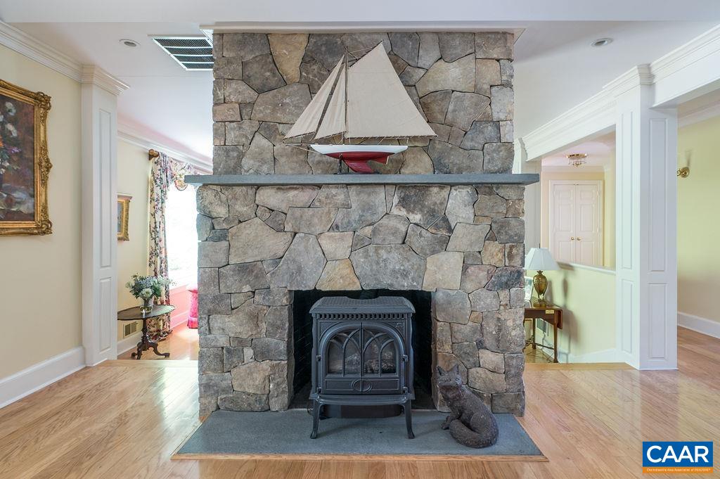 960 Windsor Road Charlottesville, VA 22901 - Photo 17 of 51 a living room with a fireplace and a wooden floor