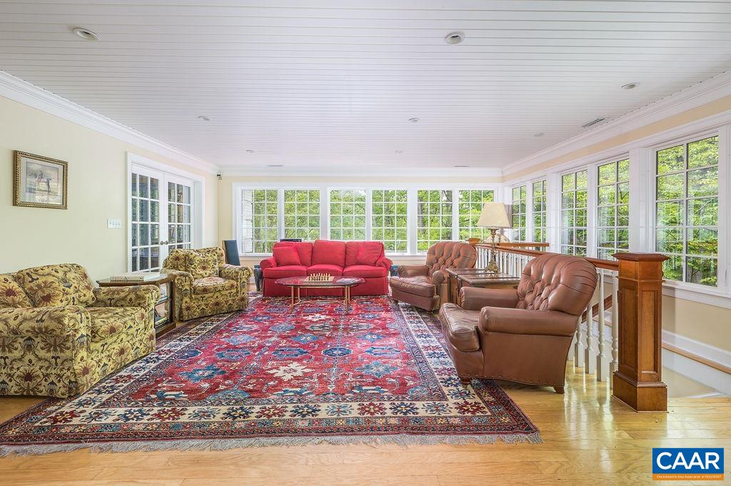 960 Windsor Road Charlottesville, VA 22901 - Photo 18 of 51 a living room with furniture floor to ceiling window and wooden floor