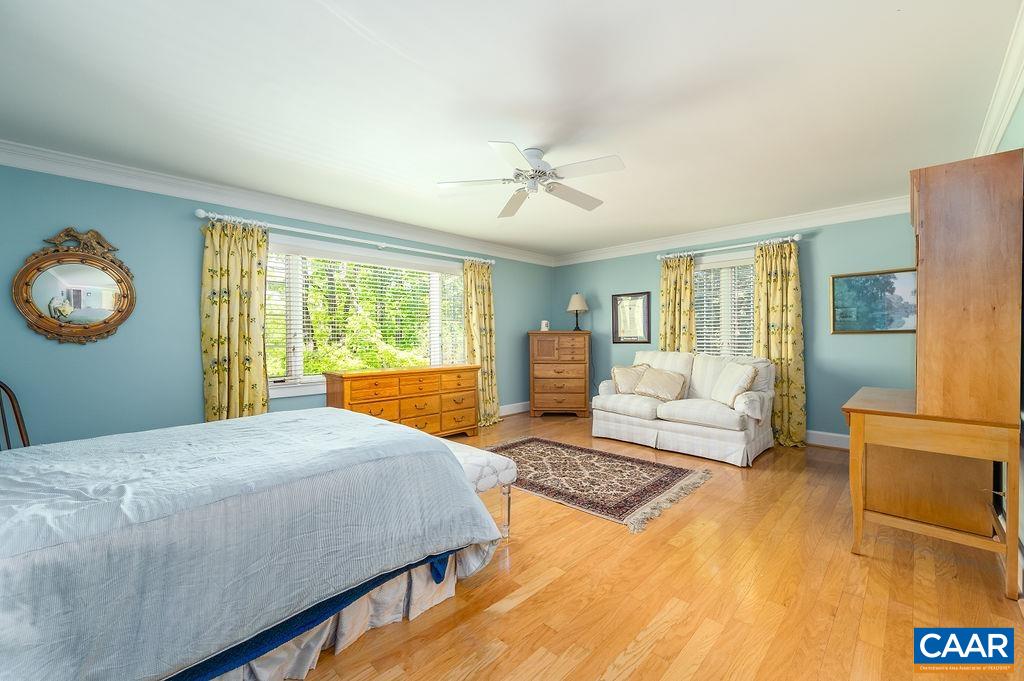 960 Windsor Road Charlottesville, VA 22901 - Photo 26 of 51 a bedroom with a large bed and a chandelier